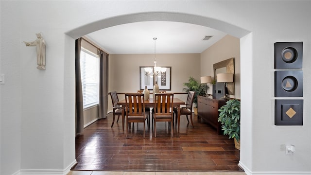 13703 View Meadow Ln, Houston, TX 77034 - dining room featuring arched walkways, dark wood finished floors, and a chandelier
