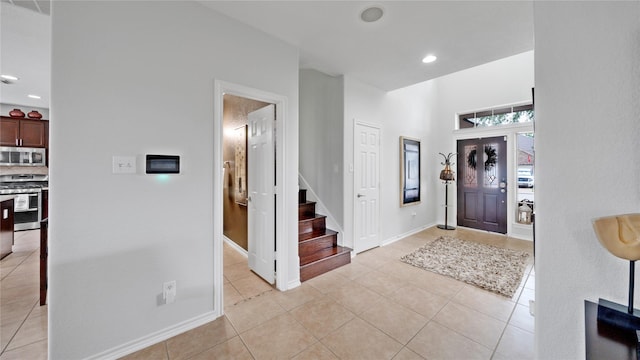 13703 View Meadow Ln, Houston, TX 77034 - entrance foyer featuring light tile patterned flooring, stairs, baseboards, and recessed lighting