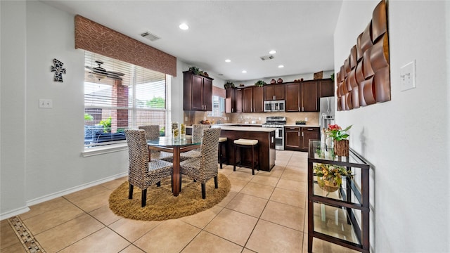 13703 View Meadow Ln, Houston, TX 77034 - dining space with recessed lighting, light tile patterned floors, and baseboards