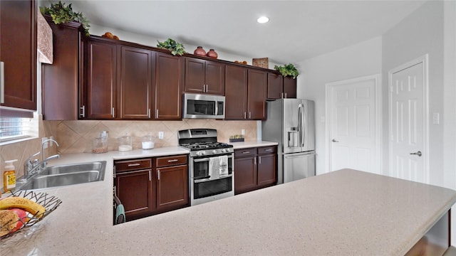 13703 View Meadow Ln, Houston, TX 77034 - kitchen featuring stainless steel appliances, a sink, light countertops, backsplash, and recessed lighting