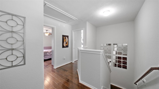 13703 View Meadow Ln, Houston, TX 77034 - hall featuring an upstairs landing, attic access, dark wood finished floors, a textured ceiling, and baseboards