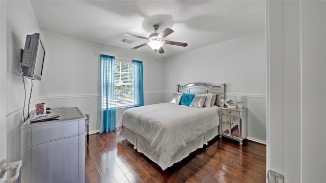 13703 View Meadow Ln, Houston, TX 77034 - bedroom featuring dark wood-style floors, a textured ceiling, a ceiling fan, and baseboards