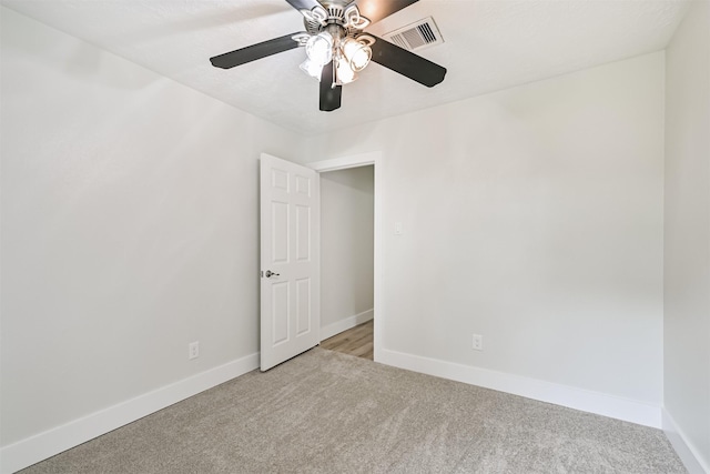1210 E Rutgers Ln, Deer Park, TX 77536 - spare room with light colored carpet, a ceiling fan, and baseboards