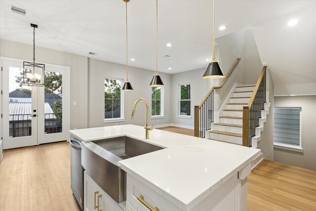 807 Martin St Unit D, Houston, TX 77018 - kitchen with a sink, light wood-type flooring, decorative light fixtures, light stone counters, and recessed lighting