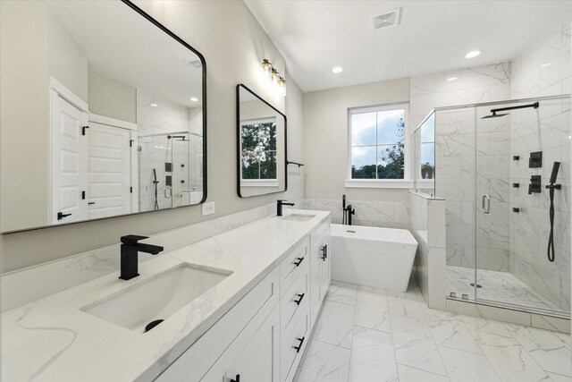 807 Martin St Unit D, Houston, TX 77018 - full bathroom featuring a soaking tub, a marble finish shower, double vanity, marble finish flooring, and recessed lighting