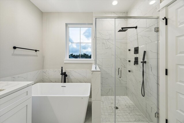 807 Martin St Unit D, Houston, TX 77018 - bathroom featuring a freestanding tub, vanity, a marble finish shower, tile walls, and recessed lighting