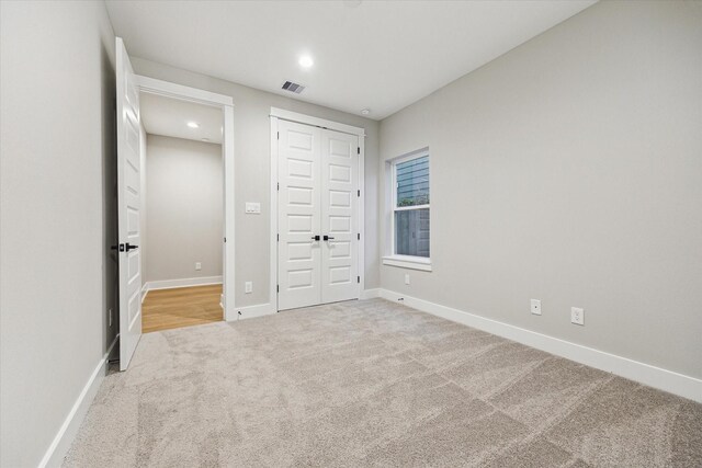 807 Martin St Unit D, Houston, TX 77018 - unfurnished bedroom featuring carpet, baseboards, a closet, and recessed lighting