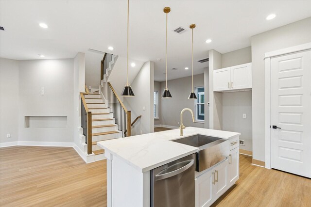 807 Martin St Unit D, Houston, TX 77018 - kitchen featuring dishwasher, a sink, light wood-style floors, white cabinets, and a center island with sink