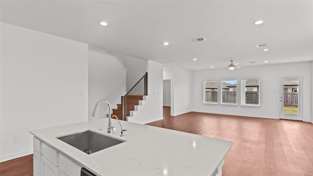 14304 Sweet Meadow Trl, Conroe, TX 77384 - kitchen with a sink, ceiling fan, dark wood finished floors, recessed lighting, and white cabinetry