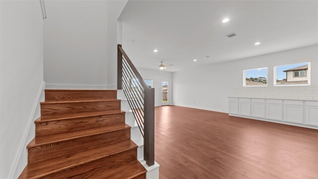 14304 Sweet Meadow Trl, Conroe, TX 77384 - stairs with healthy amount of natural light, wood finished floors, recessed lighting, baseboards, and ceiling fan