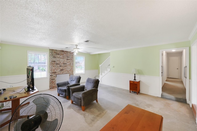 10722 Glenway Dr, Houston, TX 77070 - sitting room featuring wainscoting, a ceiling fan, stairs, ornamental molding, and a textured ceiling