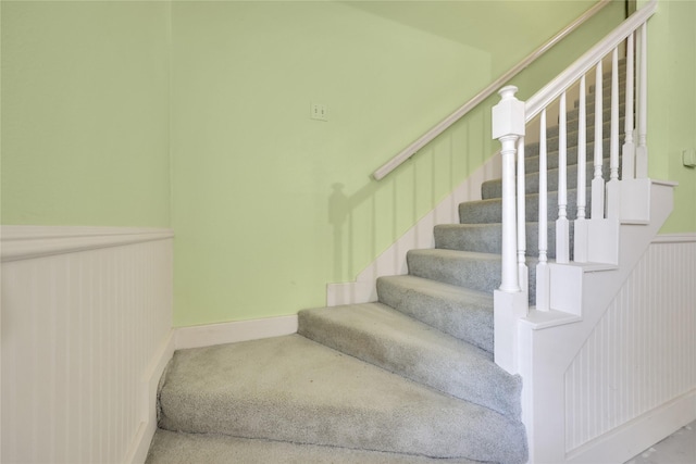 10722 Glenway Dr, Houston, TX 77070 - staircase featuring wainscoting and carpet floors