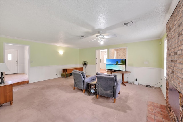10722 Glenway Dr, Houston, TX 77070 - living area with wainscoting, a textured ceiling, carpet floors, healthy amount of natural light, and a ceiling fan
