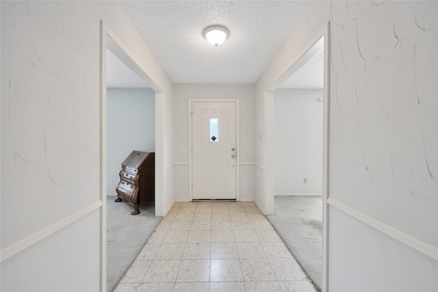 10722 Glenway Dr, Houston, TX 77070 - entryway with a textured ceiling, light carpet, and baseboards