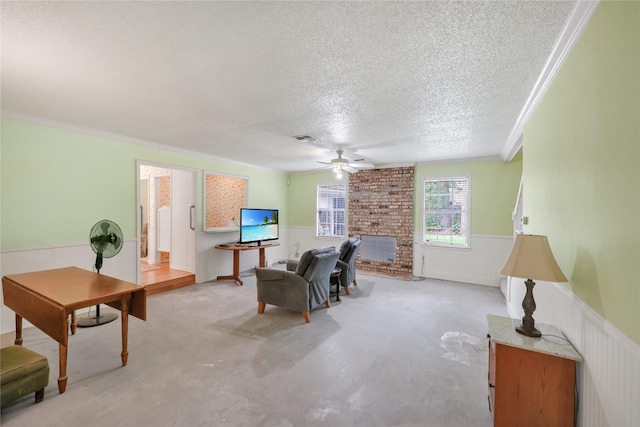 10722 Glenway Dr, Houston, TX 77070 - living room with a textured ceiling, a wainscoted wall, ceiling fan, crown molding, and a fireplace