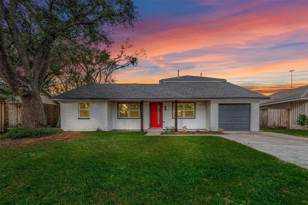 1623 Fawnhope Dr, Houston, TX 77008 - view of front facade with a garage, concrete driveway, brick siding, and roof with shingles