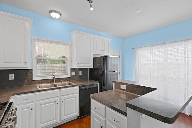 615 Columbus St, College Station, TX 77840 - kitchen with black appliances, a sink, dark countertops, tasteful backsplash, and white cabinets