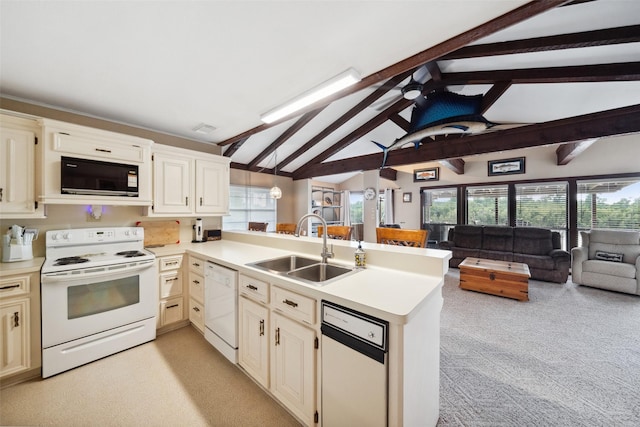215 Selkirk Rd, Matagorda, TX 77414 - kitchen featuring white appliances, a peninsula, open floor plan, a sink, and light countertops