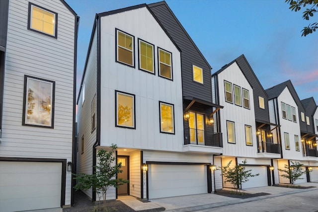 807 Martin St Unit C, Houston, TX 77018 - view of property featuring board and batten siding, an attached garage, and driveway