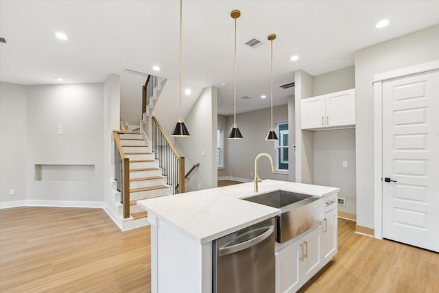 807 Martin St Unit C, Houston, TX 77018 - kitchen featuring dishwasher, a sink, light wood-style floors, white cabinets, and a center island with sink