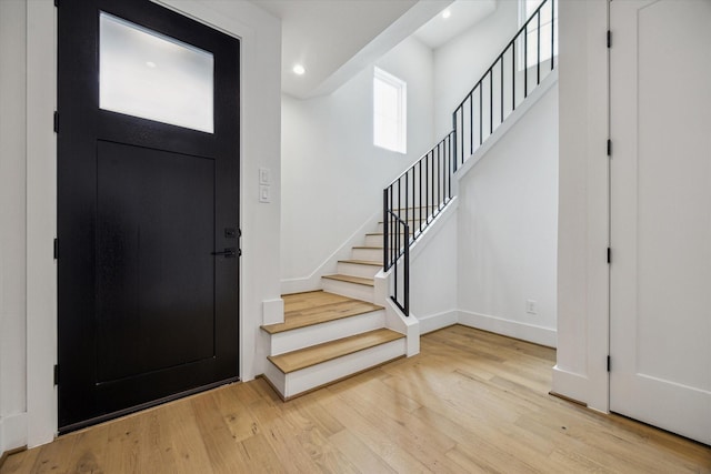 2209 Dennis St, Houston, TX 77004 - entryway featuring light wood-type flooring, stairway, baseboards, and recessed lighting