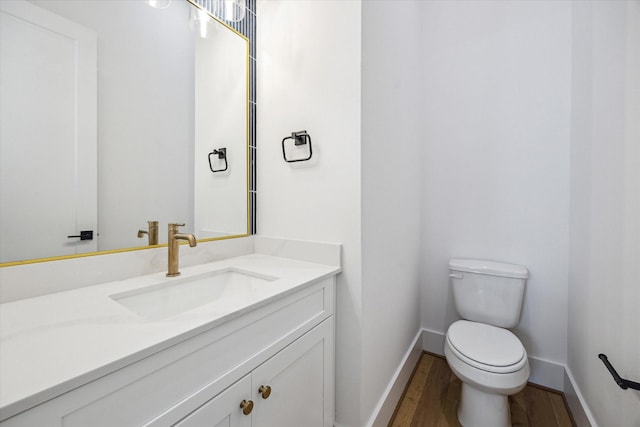 2209 Dennis St, Houston, TX 77004 - bathroom with vanity, toilet, wood finished floors, and baseboards