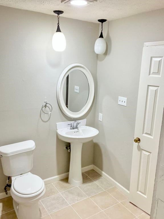 15730 Corsair Rd, Houston, TX 77053 - bathroom with tile patterned flooring, toilet, a textured ceiling, and baseboards