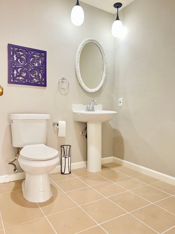 15730 Corsair Rd, Houston, TX 77053 - bathroom featuring tile patterned floors, toilet, and baseboards