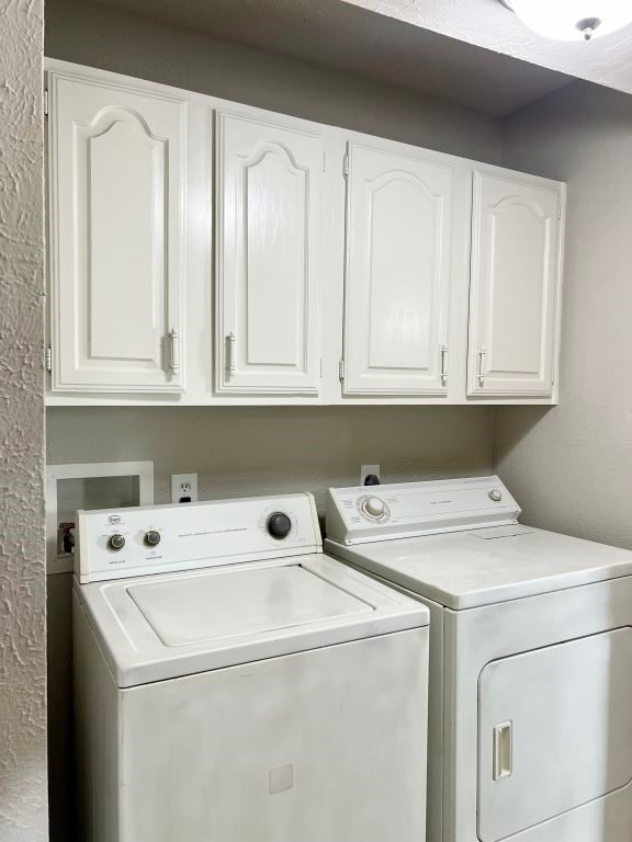 15730 Corsair Rd, Houston, TX 77053 - washroom featuring separate washer and dryer and cabinet space
