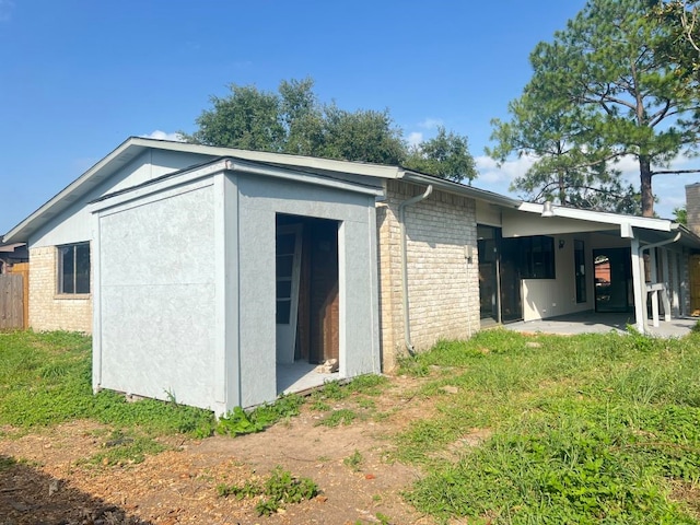 15730 Corsair Rd, Houston, TX 77053 - view of home's exterior featuring brick siding and a patio