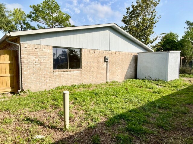 15730 Corsair Rd, Houston, TX 77053 - view of side of property featuring brick siding and a yard