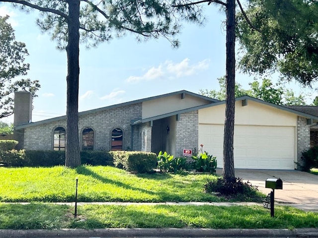15730 Corsair Rd, Houston, TX 77053 - single story home featuring a garage, brick siding, driveway, and a chimney