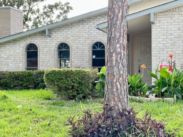 15730 Corsair Rd, Houston, TX 77053 - view of exterior entry featuring brick siding and a chimney