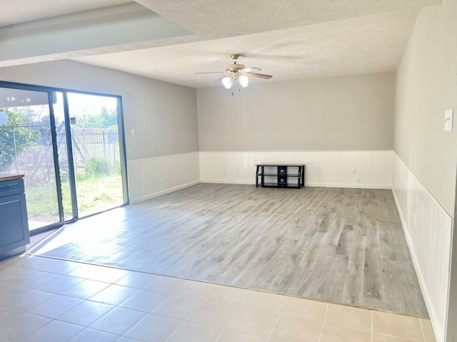 15730 Corsair Rd, Houston, TX 77053 - empty room with ceiling fan, wood finished floors, and wainscoting