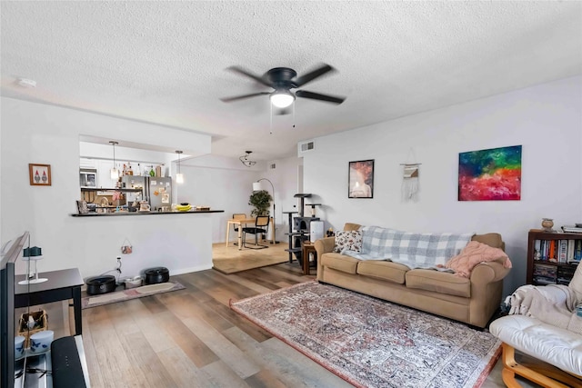 1311 Antoine Dr Unit 254, Houston, TX 77055 - living area featuring a ceiling fan, wood finished floors, and a textured ceiling