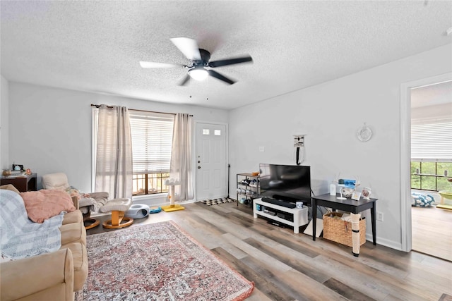 1311 Antoine Dr Unit 254, Houston, TX 77055 - living room featuring ceiling fan, wood finished floors, and a textured ceiling