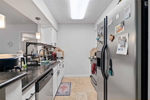 1311 Antoine Dr Unit 254, Houston, TX 77055 - kitchen featuring stainless steel appliances, white cabinets, a textured ceiling, a sink, and baseboards