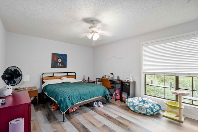 1311 Antoine Dr Unit 254, Houston, TX 77055 - bedroom with wood finished floors, a textured ceiling, and a ceiling fan