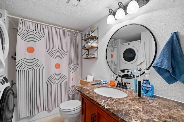 1311 Antoine Dr Unit 254, Houston, TX 77055 - full bathroom featuring stacked washer and clothes dryer, a textured ceiling, toilet, vanity, and a textured wall