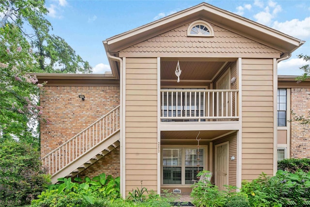 1311 Antoine Dr Unit 254, Houston, TX 77055 - rear view of house with a balcony, stairs, and brick siding
