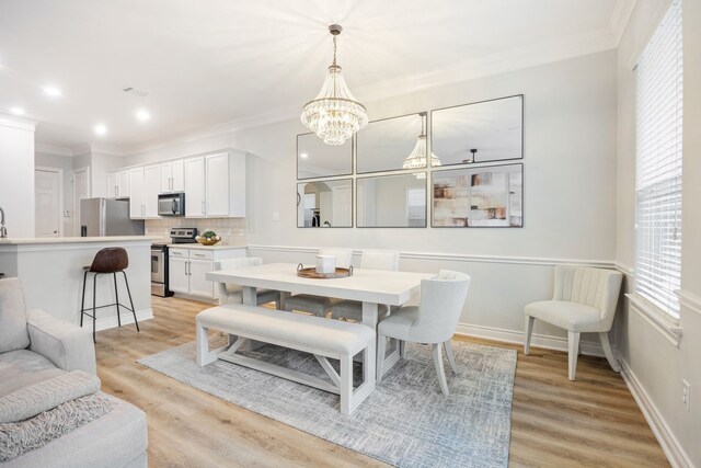 5741 Kansas St, Houston, TX 77007 - dining area featuring ornamental molding, a chandelier, light wood-style floors, recessed lighting, and baseboards