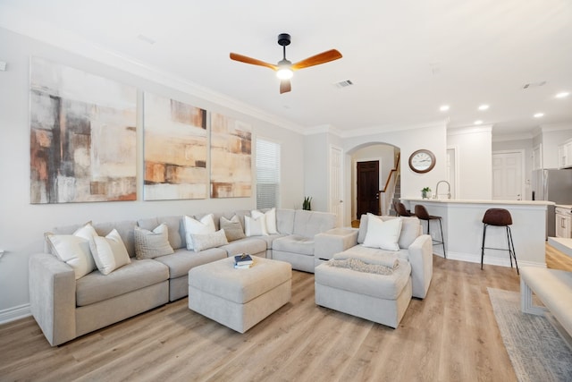5741 Kansas St, Houston, TX 77007 - living area with arched walkways, ceiling fan, light wood-type flooring, crown molding, and recessed lighting