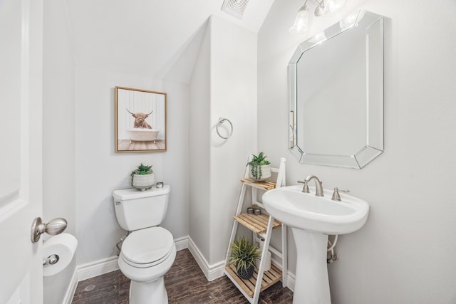 5741 Kansas St, Houston, TX 77007 - bathroom featuring toilet, wood finished floors, and baseboards