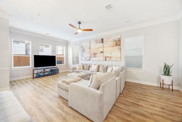 5741 Kansas St, Houston, TX 77007 - living room featuring crown molding, light wood-type flooring, a ceiling fan, and baseboards