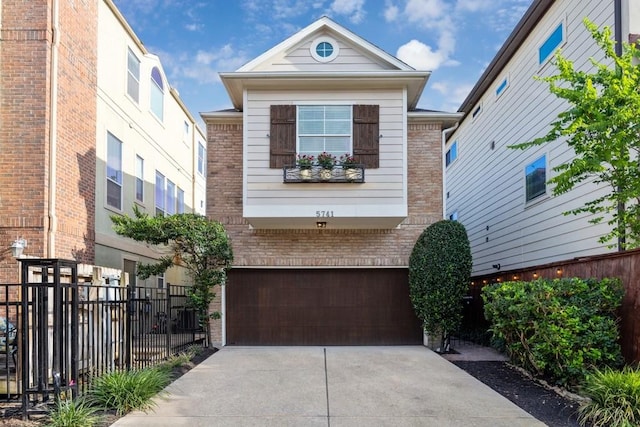 5741 Kansas St, Houston, TX 77007 - view of front of property featuring an attached garage, brick siding, and concrete driveway