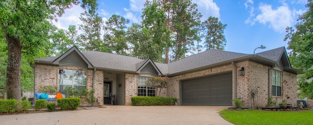 1912 Rollingwood Dr, Huntsville, TX 77340 - single story home featuring concrete driveway, an attached garage, a shingled roof, and brick siding
