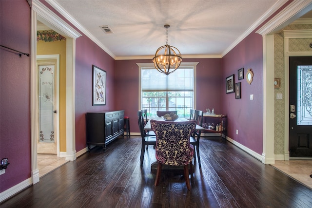 1912 Rollingwood Dr, Huntsville, TX 77340 - dining room with a chandelier, dark wood-type flooring, crown molding, and baseboards