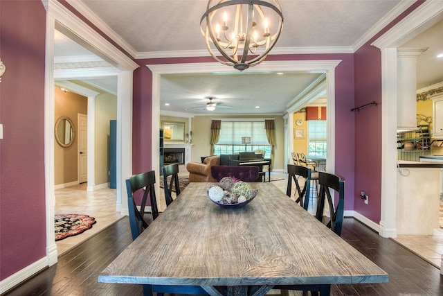 1912 Rollingwood Dr, Huntsville, TX 77340 - dining room with a fireplace, baseboards, hardwood / wood-style flooring, a chandelier, and crown molding