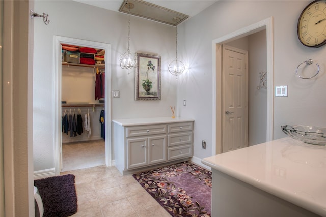 1912 Rollingwood Dr, Huntsville, TX 77340 - bathroom featuring vanity, tile patterned flooring, and a walk in closet