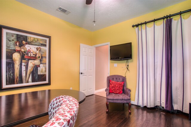 1912 Rollingwood Dr, Huntsville, TX 77340 - sitting room featuring wood finished floors, baseboards, and a textured ceiling